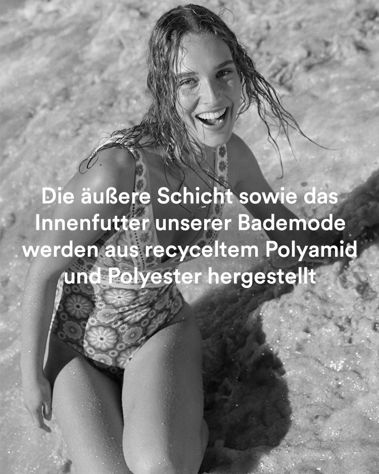 Woman on beach in Boden swimsuit