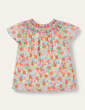 Top tissé à empiècement smocké-Lit de fleurs tropicales