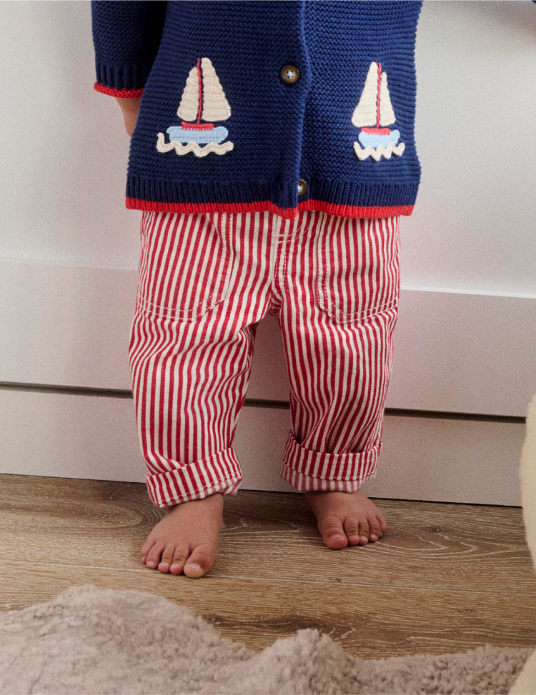 Baby's legs wearing red and white striped Boden trousers