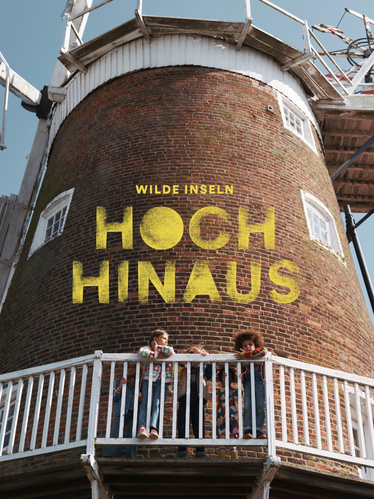 Wilde Iseln: Hoch Hinaus. Four children stood around a windmill wearing Boden clothes