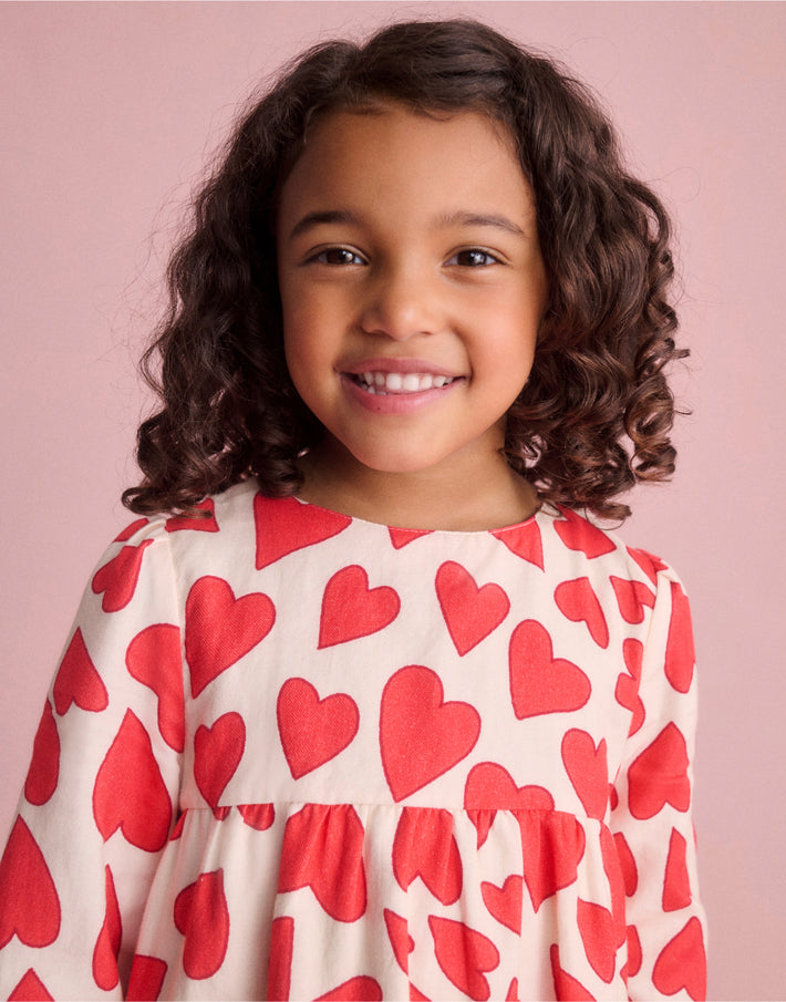 Girl wearing Boden love heart dress