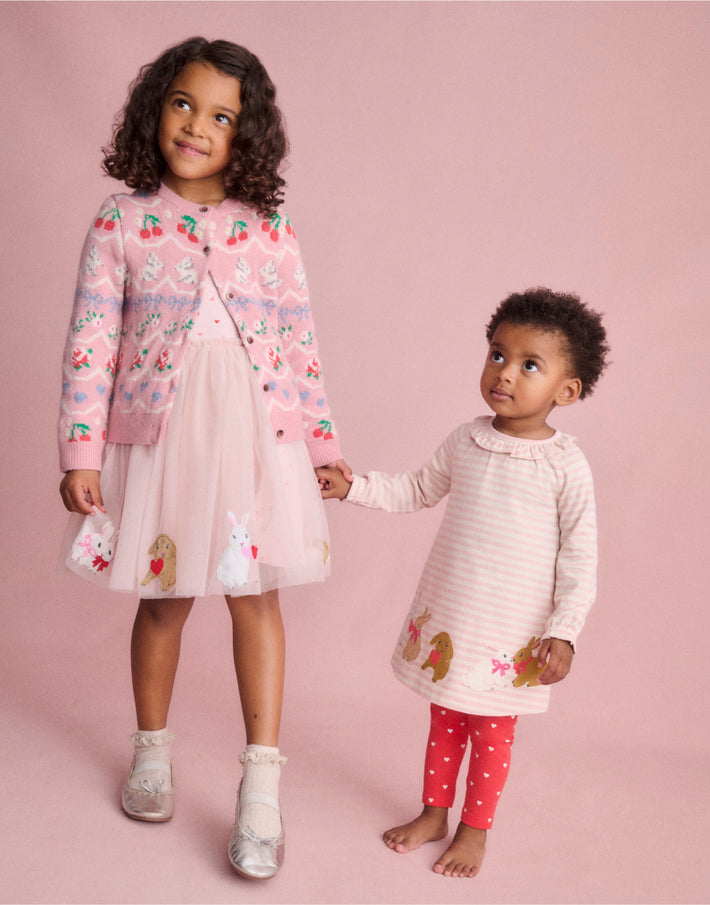 Two girls wearing Boden bunny dresses